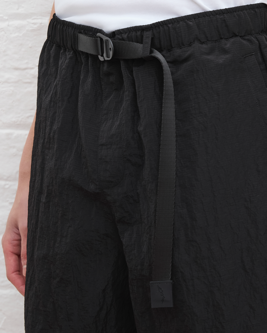 Black pants with a belt on a light background